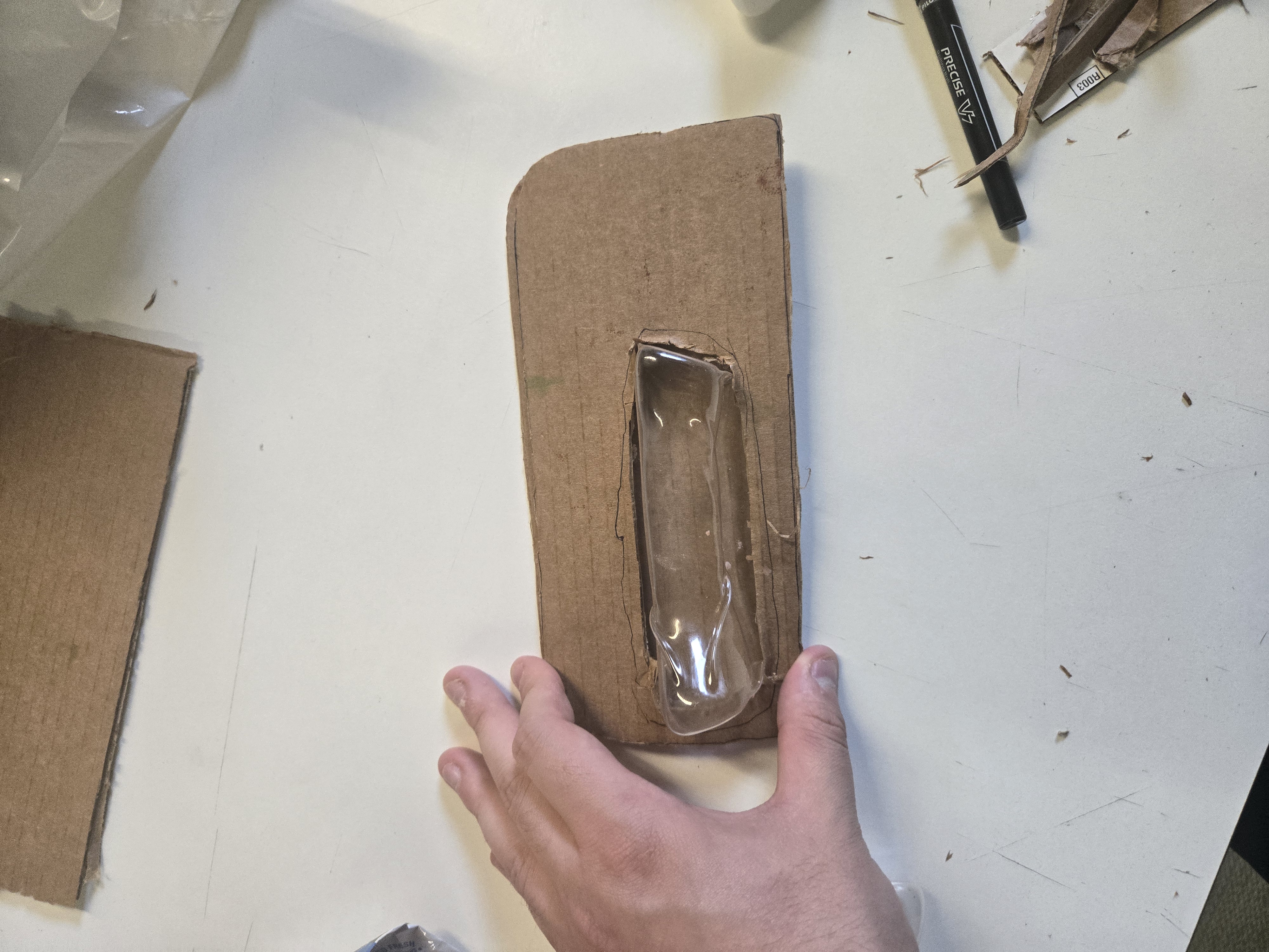 DONE. early packaging prototype — cardboard hang card with plastic window in progress