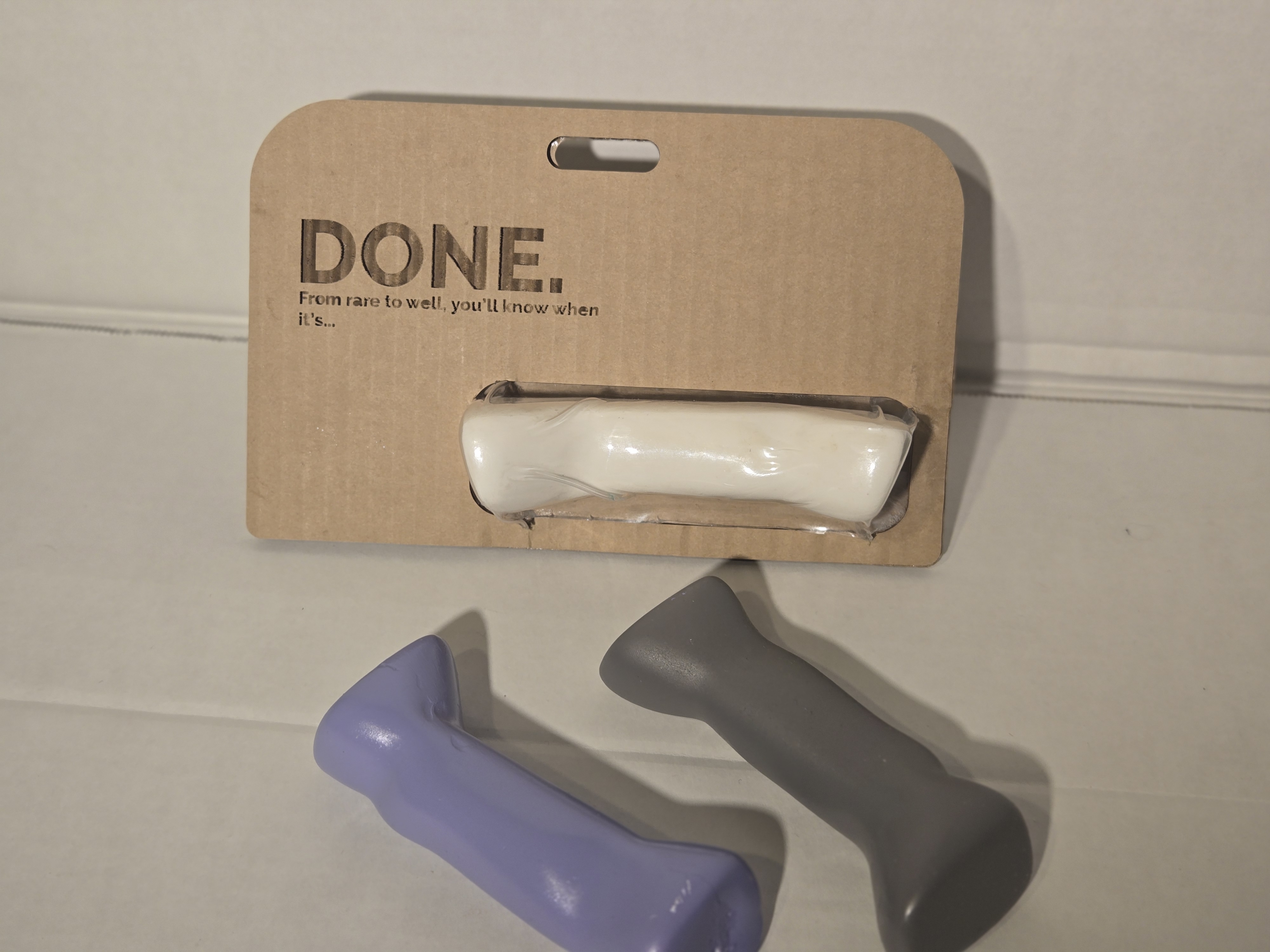 DONE. injection-molded handles with kraft hang card — prototype mounted in window cutout