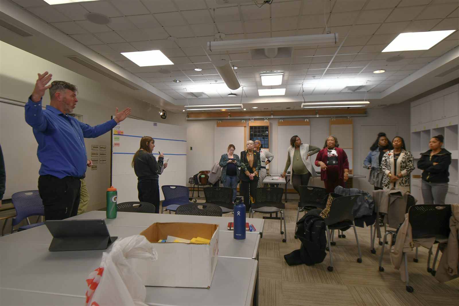 Workshop session — facilitator presenting to the full group in the design studio