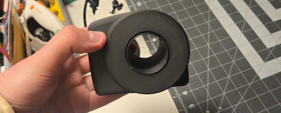 V1 prototype — black PETG, bore geometry and hand scale test