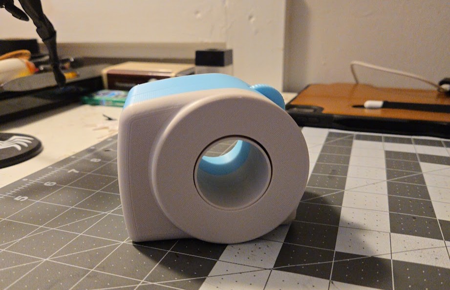 V2 prototype — blue and white two-part assembly with spinning dial